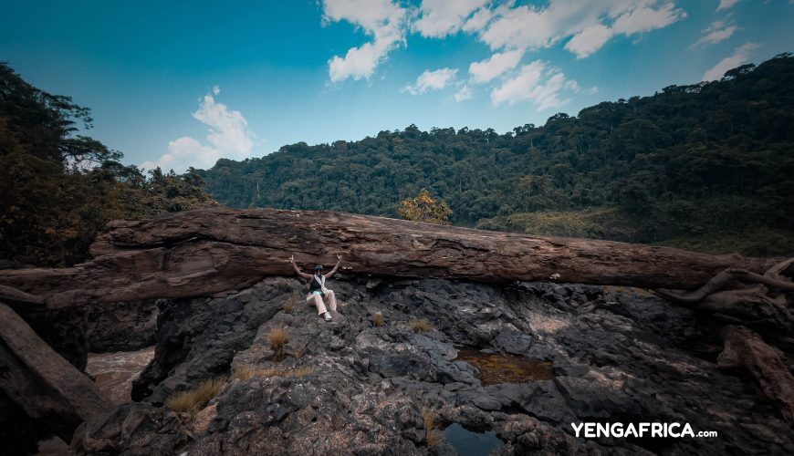 Solo female traveler at the top of the ekom nkam falls during the dry season - YENGAFRICA