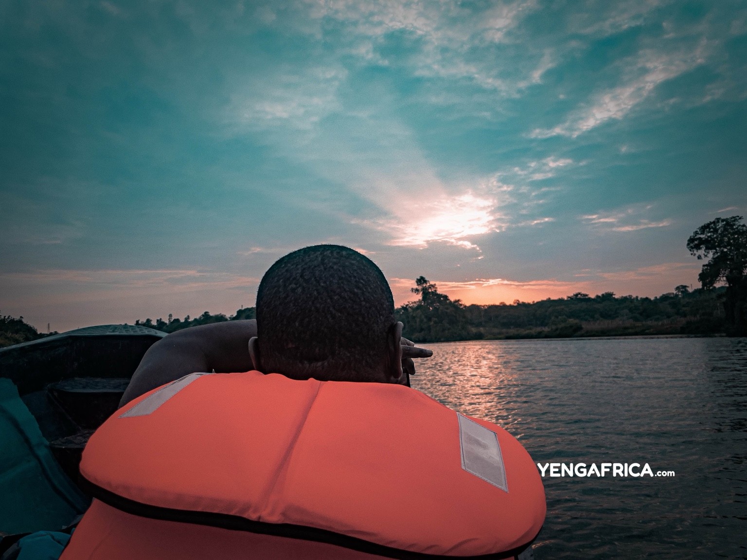 Tourist capturing the sunset during a boat tour of the sanaga Gorges in Edea
