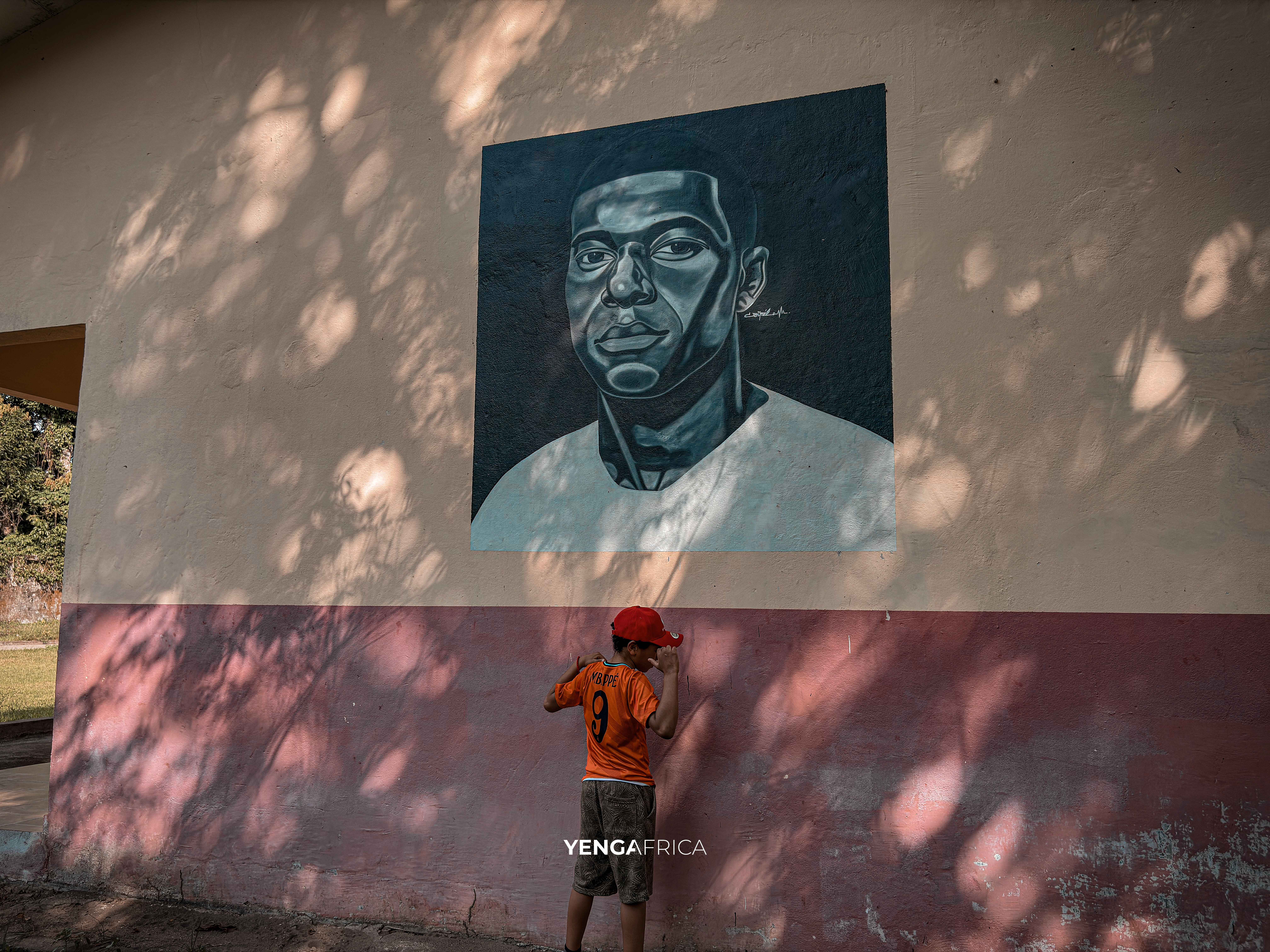 Child posing in front of the painting of his idol Kylian mbappe at Jebale island